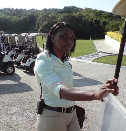 Denieve Dixonnext to a golf car.