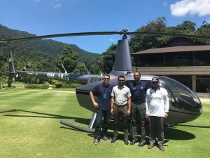 Steve Outlaw, Third from left, with three others standing in front of a helicopter